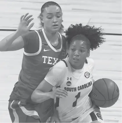  ?? MORRYGASH/AP ?? South Carolina’s Zia Cooke drives past Texas’s Celeste Taylor during the first half of the Gamecocks’victory Tuesday night in the Elite Eight contest at the Alamodome in San Antonio.