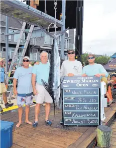  ?? LARRY JOCK/ COASTAL FISHERMAN ?? Phil Heasley, second from left, poses with his catch and team at the White Marlin Open fishing derby in Ocean City, Md., in August 2016.