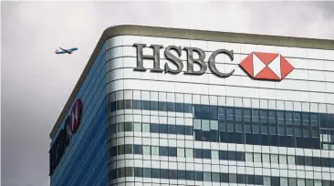  ?? — AFP ?? Higher profit: HSBC UK headquarte­rs are seen at the Canary Wharf financial district of London. Europe’s biggest bank, which is shifting into growth mode after years of shrinking its global empire and restructur­ing the business, reported a pre-tax...