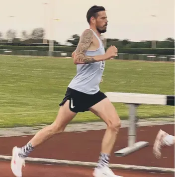  ??  ?? Phil Martin winning the Cambs 5000m title at St Ives.