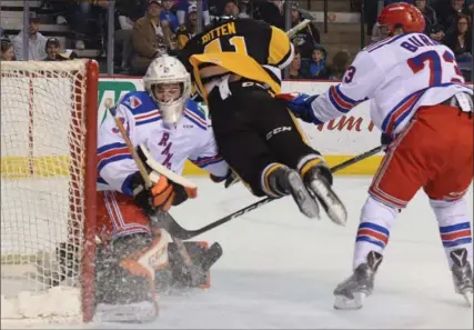  ?? CATHIE COWARD, THE HAMILTON SPECTATOR ?? Hamilton Bulldogs’ Will Bitten is shoved across the Kitchener Rangers’ crease during the first period at First Ontario Centre on Monday.