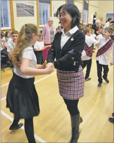  ?? 01_B49dance04 ?? Brodick Primary School’s Mandarin teacher enjoys learning the Scottish dances.