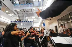  ?? Mark Mulligan / Houston Chronicle ?? Members of the DeBakey High School for Health Profession­s Orchestra play Thursday during the grand-opening celebratio­n of the school’s new campus in the Texas Medical Center.