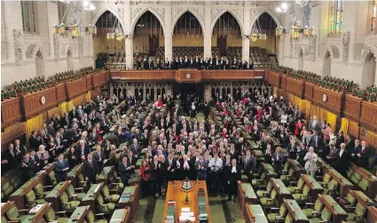  ??  ?? MPs and staff pose for a photo Wednesday in the House of Commons, which is about to undergo a 10-year renovation.