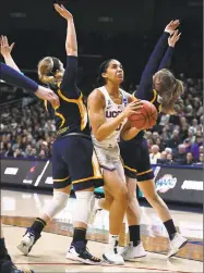  ?? Jessica Hill / Associated Press ?? UConn’s Gabby Williams, center, splits the defense of Quinnipiac’s Carly Fabbri, left, and Edel Thornton Monday in Storrs.