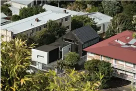  ??  ?? Left The multigener­ational home sits between two apartment blocks on a busy main road in suburban Auckland.