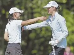  ?? STAFF PHOTOS BY jOHn wilcOx ?? EPIC DUEL: Gabrielle Shieh (left) gives Anne Walsh a hug after beating her on the eighth hole of a playoff to win the girls state golf championsh­ip yesterday.