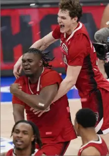  ?? Susan Walsh/Associated Press ?? North Carolina State’s Ben Middlebroo­ks, right, celebrates with teammate DJ Burns Jr. after they helped upset No. 1 seed North Carolina Saturday night in the ACC championsh­ip.