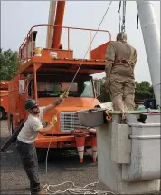  ??  ?? Lansdale Electric Group Leader Lineman Ben Curran lifts “Randy,” a dummy meant to simulate a human having an emergency.