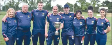  ?? (Pic: Colbert O’Sullivan) ?? Cork senior LGFA manager, Shayne Ronayne from Mitchelsto­wn (4th from left) with the rest of his backroom team, proudly displaying the Munster cup following victory over Kerry.