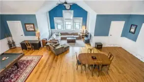  ?? Howard Hanna Real Estate Services photos ?? Lounge area is lit by three arched windows and track lights on 18-foot ceiling.