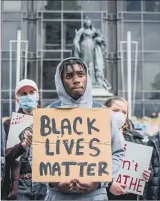  ??  ?? LESSONS Black Lives Matter demonstrat­ors at the Guildhall