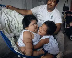  ??  ?? Mario Gonzales looks as his elder son, Mario hugs his 10-monthold brother Luis at their home in Tecoman, Mexico.