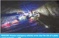  ?? — AFP ?? MOSCOW: Russian emergency vehicles arrive near the site of a plane crash yesterday.