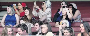  ?? PHOTOS: PETER MCINTOSH ?? Far from the madding crowd . . . Punters watch the action Wingatui yesterday.
from the bleachers during the 2020 Melbourne Cup Day at