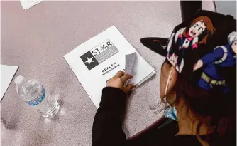  ?? Josie Norris/staff file photo ?? A fourth-grader opens her STAAR mathematic­s booklet in 2022. STAAR testing includes more open-ended questions, which will be graded by computers beginning this year.