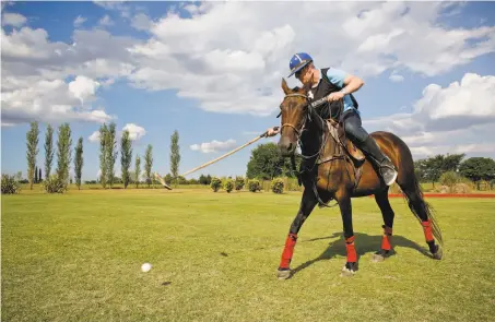  ?? Victor R. Caivano / Associated Press ?? Martin Folan, a tourist from London, hits the ball during a polo practice at La Carona club in Buenos Aires province, Argentina.