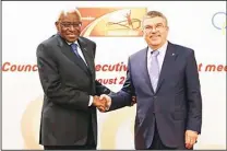  ??  ?? In this Aug 21, 2015 file photo, IOC president Thomas Bach (right), shakes hands with IAAF President Lamine Diack during a joint IOC and IAAF press conference on the side of the World Athletic Championsh­ips
in Beijing. (AP)