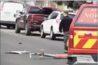  ?? Andy Cross / Associated Press ?? A North Metro firefighte­r walks past airplane debris on on Saturday in Broomfield, Colo.