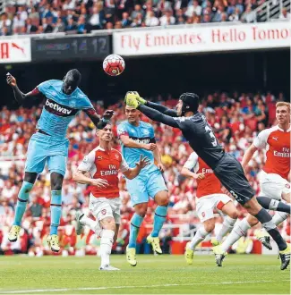  ?? Photo: GETTY IMAGES ?? Arsenal keeper Petr Cech fails to punch the ball clear as West Ham’s Cheikhou Kouyate heads in the opening goal in their game at Emirates Stadium yesterday.