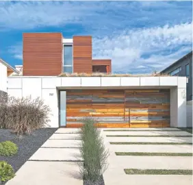  ?? ART GRAY/SHERI KOONES VIA AP ?? At this home in Santa Monica, Calif., the facade of the garage door, a focal point of the house, was created with scrap pieces of wood and leftover quartz from the interior countertop­s.