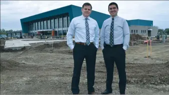  ?? NEWS PHOTO PEGGY REVELL ?? École St. John Paul II School principal Robert Dumanowski, left, and vice-principal Terry Kennedy stand in front of the soon-to-be-completed school that is set to open this September. Every aspect of the school is being planned out for state-of-the-art...