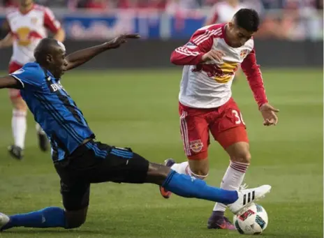  ?? VINCENT CARCHIETTA/USA TODAY SPORTS ?? Impact defender Hassoun Camara stretches to stop the run of Red Bulls midfielder Gonzalo Veron during Sunday’s Eastern conference semifinal clash.