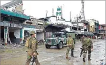  ?? TED ALJIBE/AFP ?? Philippine soldiers walk past battle-scarred buildings, including a mosque, in Marawi on October 17, 2017.