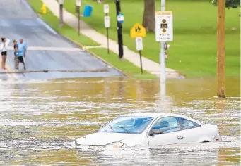  ?? AMY SHORTELL/THE MORNING CALL ?? A car is submerged on Union Street in Allentown on Tuesday.