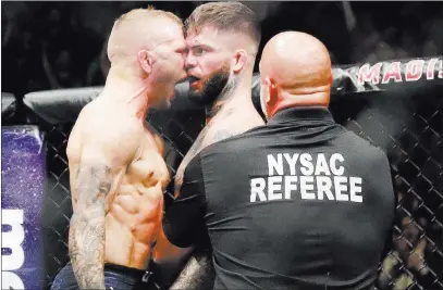  ?? Frank Franklin II ?? The Associated Press T.J. Dillashaw, left, unleashes his rage after beating Cody Garbrandt for the bantamweig­ht title at UFC 217 on Nov. 5 in New
York. The two have a rematch Saturday at Staples Center in Los Angeles.