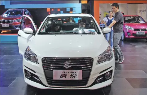  ?? PHOTOS PROVIDED TO CHINA DAILY ?? A Suzuki Alivio model is displayed at an auto show in Dongguan, Guangdong province. The carmaker is to dissolve its existing Chinese joint venture due to a sales slump and fierce competitio­n.