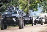  ?? Bullit Marquez / Associated Press ?? Military convoy heads to Marawi, a city in southern Philippine­s under siege by Muslim extemists.