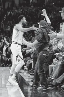  ?? Andy Cross, The Denver Post ?? Denver Nuggets guard Jamal Murray, a former first-round draft pick from Kentucky, celebrates with fans after hitting a 3-pointer at the buzzer to end the first quarter against the Golden State Warriors at the Pepsi Center on Jan. 15.