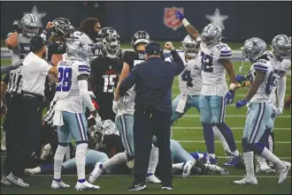  ?? The Associated Press ?? CHARACTER CHECK: Dallas Cowboys head coach Mike McCarthy, center with hand raised, celebrates an onside kick recovery in the second half of Sunday’s game against the Atlanta Falcons in Arlington, Texas.