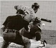  ??  ?? Maldonado lays down a sacrifice bunt to advance two runners during Friday’s game.