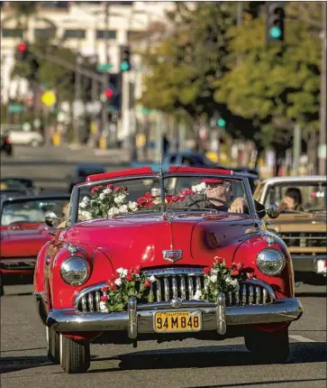  ?? Irfan Khan Los Angeles Times ?? SULTANS CAR Club of Long Beach and its friends went on a “Rose Parade Cruise” along Colorado Boulevard on Jan. 1 after the parade was canceled. Next year’s event will celebrate essential workers and healthcare staff.