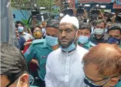  ?? (AFP) ?? Police escort Mamunul Haque, a joint secretary of hardline Hefazat-eIslam group, following his arrest in Dhaka on Sunday