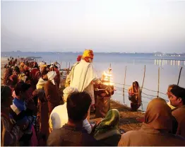  ?? — AFP ?? Devotees perform Ganga aarti at Sangam during the annual Magh Mela festival in Allahabad on Thursday.