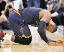  ?? DARREN ABATE/ THE ASSOCIATED PRESS ?? Cleveland forward LeBron James falls to the floor during the second half against San Antonio on Monday in San Antonio. James and the Cavaliers lost 103-74 to fall behind Boston in the race for the top seed in the Eastern Conference playoffs.