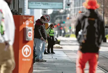  ?? Photos by Yi-Chin Lee / Staff photograph­er ?? Metropolit­an Transit Authority rail passengers wait for a train Wednesday at the Main Street Square station downtown. Federal guidelines now require mask-wearing on all publicly accessible transporta­tion, including trains and buses.