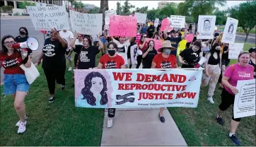  ?? ROSS D. FRANKLIN — THE ASSOCIATED PRESS ?? Thousands of protesters march around the Arizona Capitol in protest after the Supreme Court decision to overturn the landmark Roe v. Wade abortion decision Friday, June 24, 2022, in Phoenix. An Arizona Supreme Court ruling on Tuesday, allowing enforcemen­t of an abortion ban, is the latest action to elevate abortion as a key political issue this year.