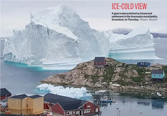  ?? Picture: Reuters ?? A giant iceberg behind an Innaarsuit settlement in the Avannaata municipali­ty, Greenland, on Thursday.