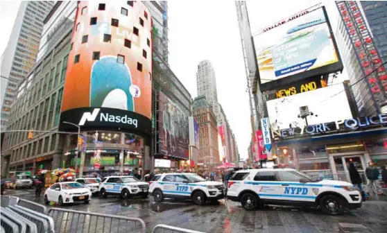  ??  ?? NEW YORK: A row of New York City police cars is parked along a street in Times Square.—AP