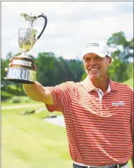  ?? Butch Dill / Associated Press ?? Steve Stricker holds up the trophy after winning the Regions Tradition Champions Tour golf tournament on Monday in Birmingham, Ala.