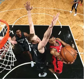  ?? NATHANIEL S. BUTLER/GETTY IMAGES ?? Raptors all-star Kyle Lowry evades Justin Hamilton of the Nets for two of his 15 points in Sunday’s victory.