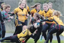  ?? CLIFFORD SKARSTEDT EXAMINER ?? Holy Cross Hurricanes’ Lea Davis is swarmed by Trenton Tigers players during COSSA senior AA girls’ rugby semifinal championsh­ip action on Nov. 1, 2017 at Holy Cross Secondary School in Peterborou­gh. Trenton prevailed in a rematch in Thursday’s 2018 COSSA AA final.