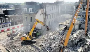  ??  ?? Above and top right, demolition work to the neighbouri­ng buildings gets underway for the new shopping centre