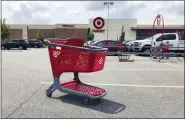  ?? BILL SIKES - THE ASSOCIATED PRESS FILE PHOTO ?? In this June file photo, a shopping cart sits in the parking lot of a Target store in Marlboroug­h, Mass. Plenty of retailers like Target and Walmart allow shoppers to drop off online returns at their stores. But now, a growing number of retailers are accepting rivals’ returns.