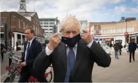  ??  ?? Boris Johnson visiting his constituen­cy, Uxbridge in west London, last week, after announcing restrictio­ns ‘for perhaps six months’. Photograph: Stefan Rousseau/PA