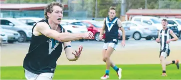  ??  ?? Left - It may still be some time until we see players in action like Nick Pratt here, who fires off a handball during last season for his Yarragon side.